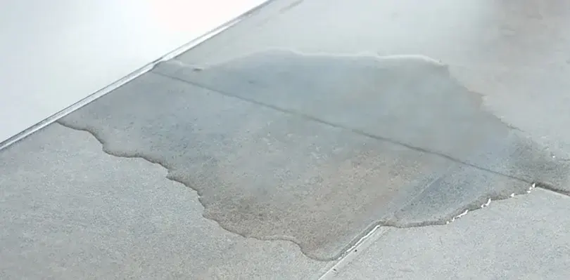 Water spreading across a bare concrete floor in Pico Rivera, CA