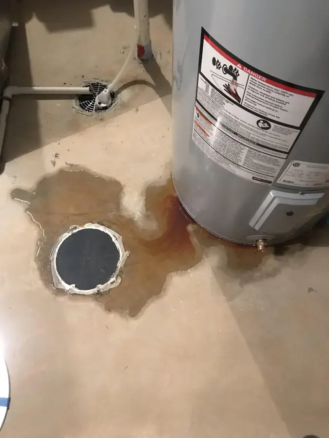 Water pooled around the base of a water heater and a floor drain in Pico Rivera, CA