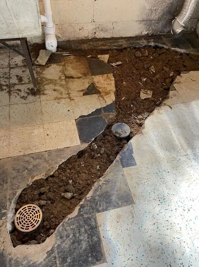Tile floor trenched open down to the soil to reach a pipe under the slab in Pico Rivera, CA