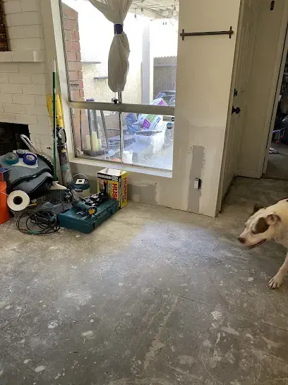 Drying equipment staged on a bare concrete floor after the wet flooring came out in Pico Rivera, CA