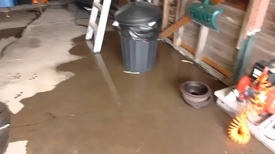 Standing water spread across a garage slab before extraction in Pico Rivera, CA